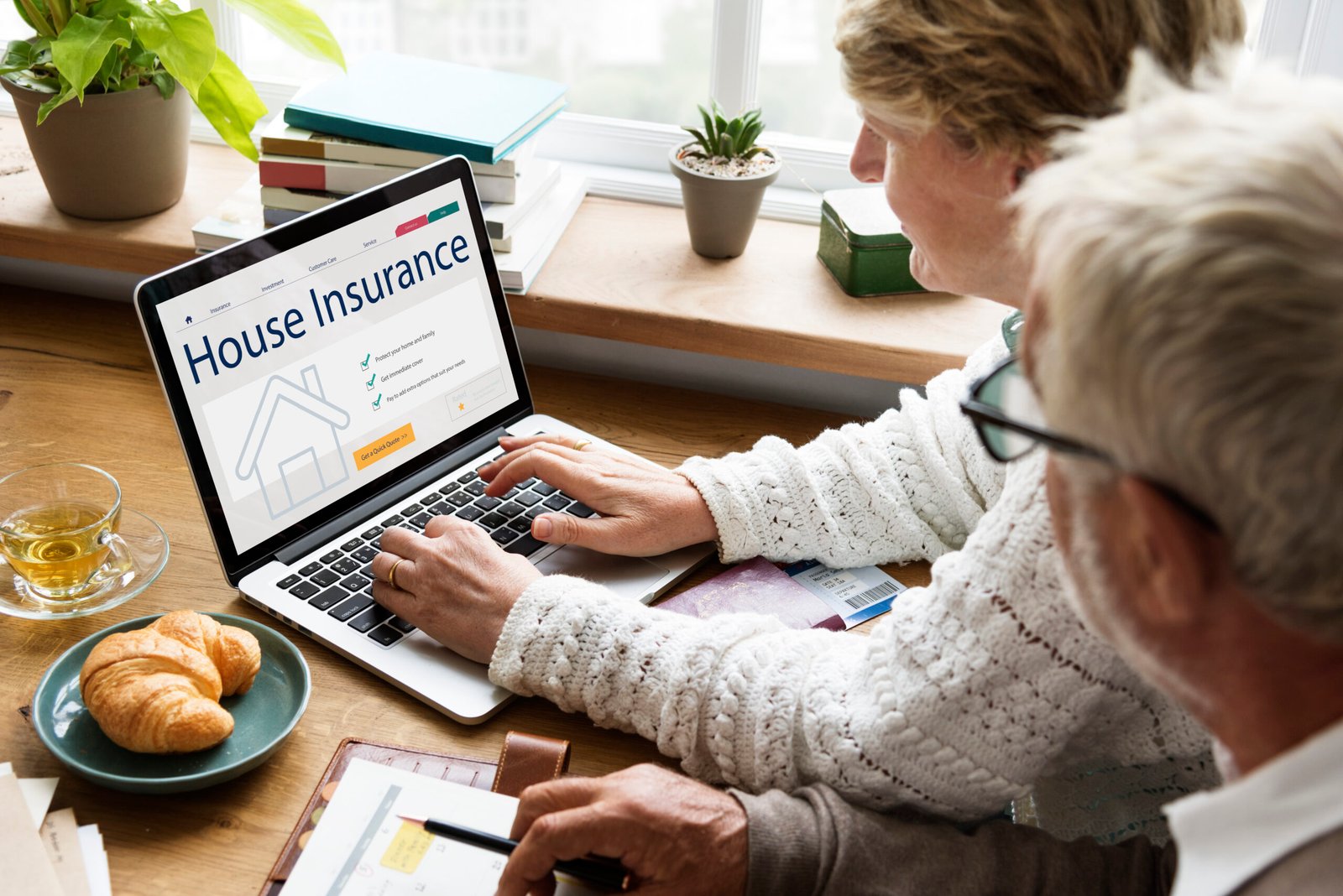 senior-couple-consulting-house-insurance-laptop